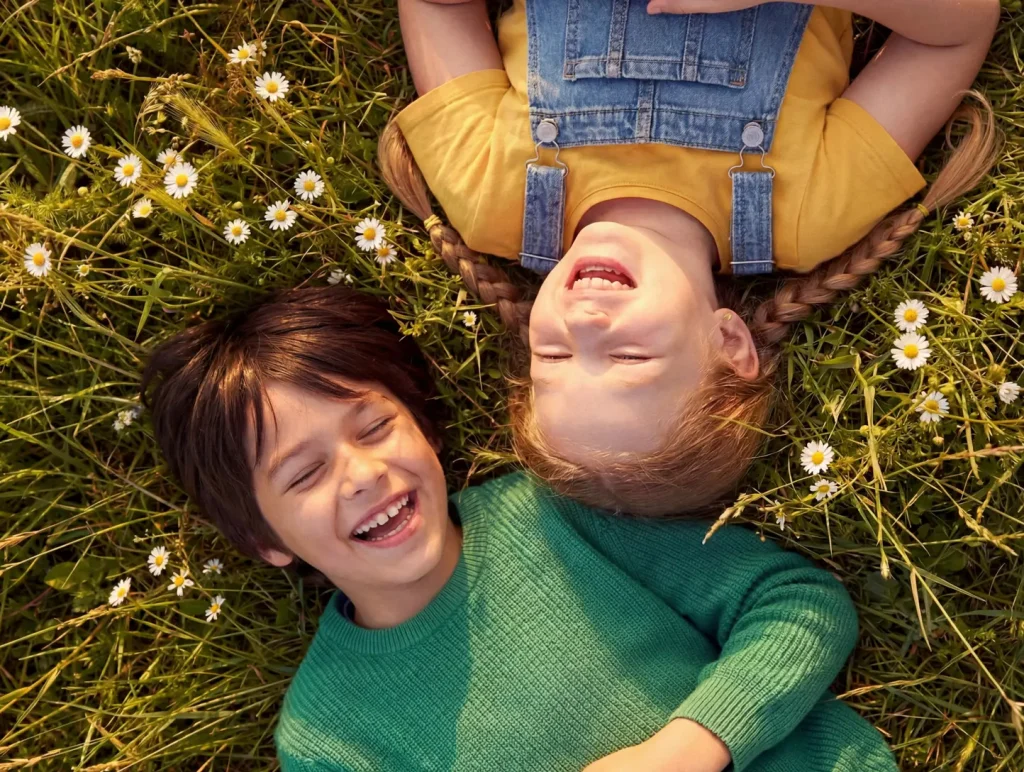 Children enjoying a sunny meadow, community lifestyle image